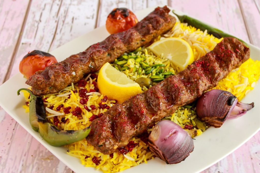 Platter of marinated meats and saffron rice from a Persian Grill.